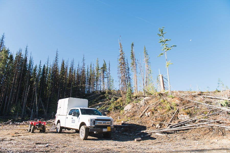 An A+G ATV sits parked next to an A+G crew truck on the cut block